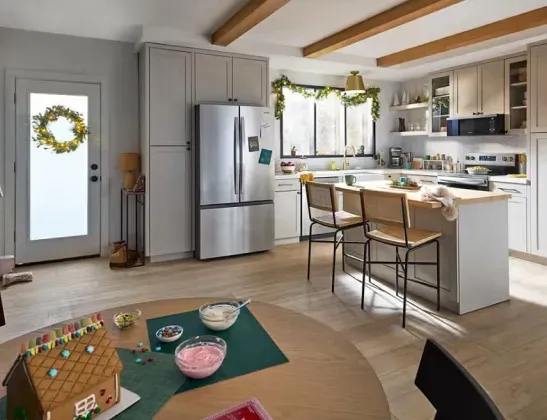 The Whirlpool WRFF3136SZ French Door Refrigerator in stainless steel installed in a modern kitchen decorated for the holidays.